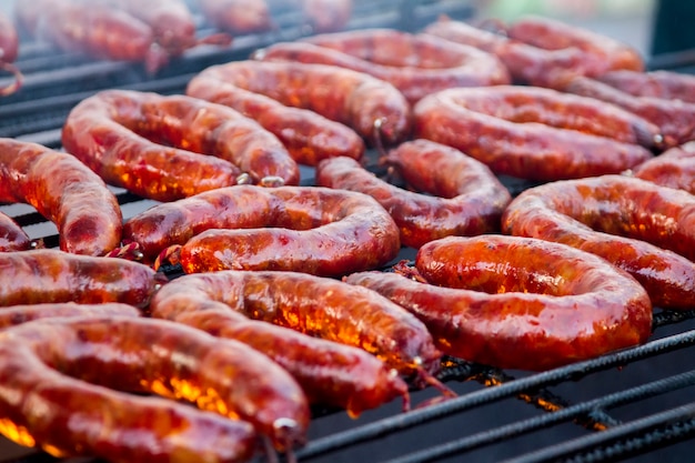 Close up view of many portuguese chorizos on a barbecue. 