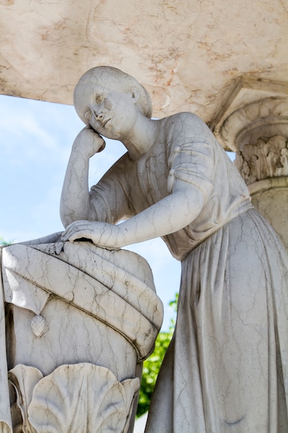Close up view of a marble statue located on a cemetery in Lisbon.