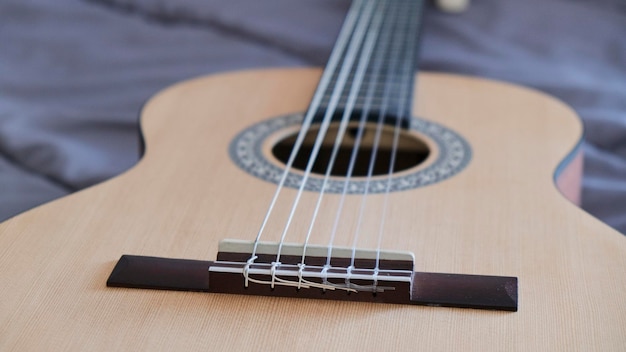 Close up view of matte wooden acoustic guitar