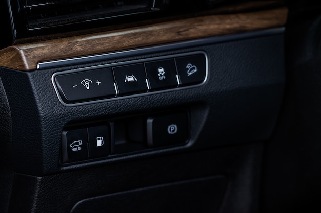 Close up view of modern car electronic safety systems control panel. Modern car interior detail.