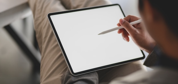 Photo close-up view of modern office room with  tablet and office supplies on white table
