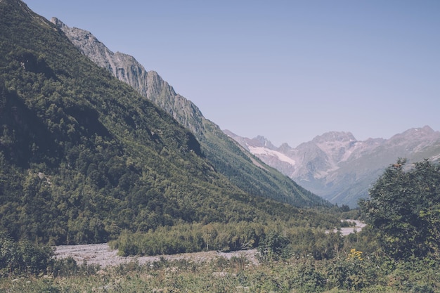 Close up view mountains and river scenes in national park Dombai, Caucasus, Russia, Europe. Summer landscape, sunshine weather, dramatic blue sky and sunny day