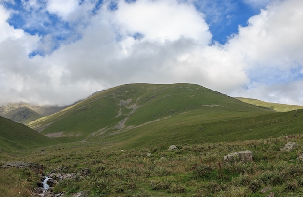 Close up view mountains scenes in national park Dombai, Caucasus, Russia, Europe. Summer landscape, sunshine weather, dramatic blue sky and sunny day