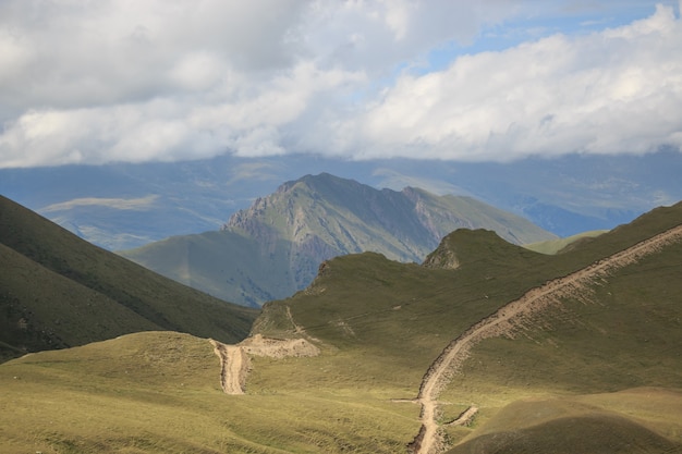 Close up view mountains scenes in national park Dombai, Caucasus, Russia, Europe. Summer landscape, sunshine weather, dramatic blue sky and sunny day