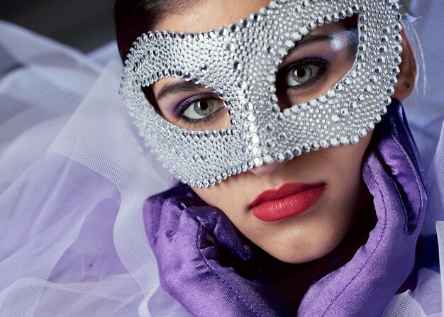 Close-up view of mysterious woman with carnival mask