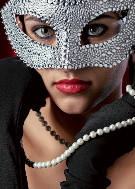 Close-up view of mysterious woman with carnival mask