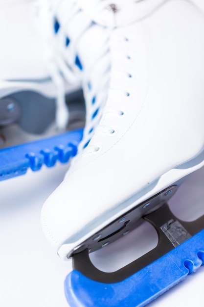 Close up view. new white figure skates on a white\
background.