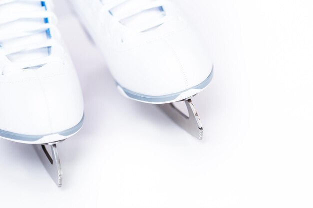 Close up view. New white figure skates on a white background.