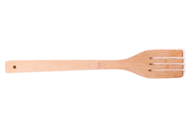 Close up view of one wooden fork isolated on white background.