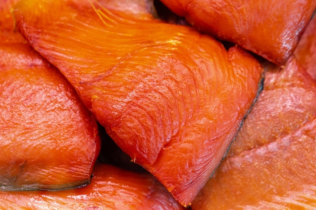 Close up view of piece cold smoked salted Pacific red fish Chinook Salmon. Prepared and ready-to-eat Pacific seafood. King Salmon - Asian delicacy cuisine as an appetizer for any garnish, festive dish