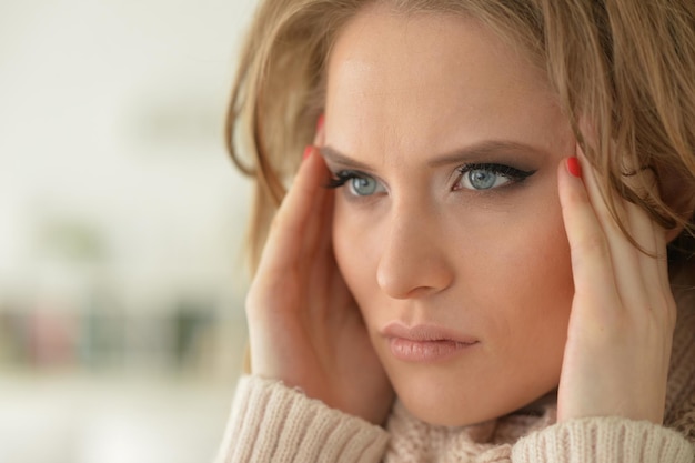 Close up view of sad young woman posing