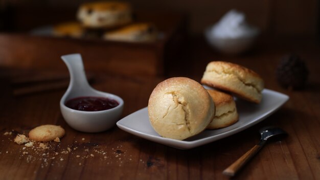 Close up view of scones on plate  with strawberry jam