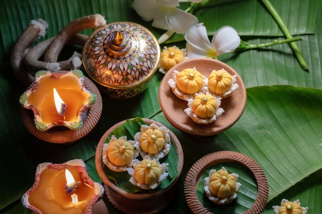 Close up view of several Thai traditional desserts served on banana leaves