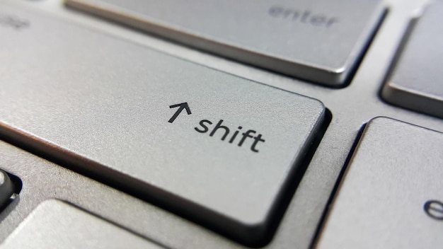 Close up view of shift key button on computer laptop keyboard