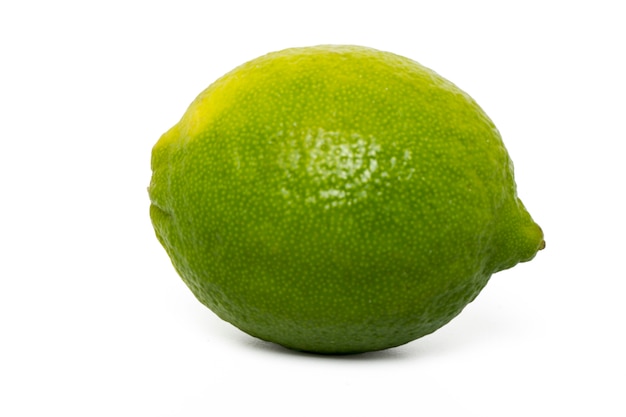 Close up view of a single lime fruit isolated on a white background.