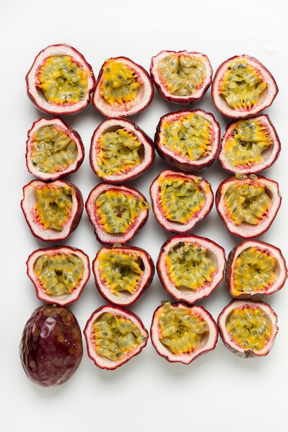 Close up view of sliced passion fruits isolated on a white background.