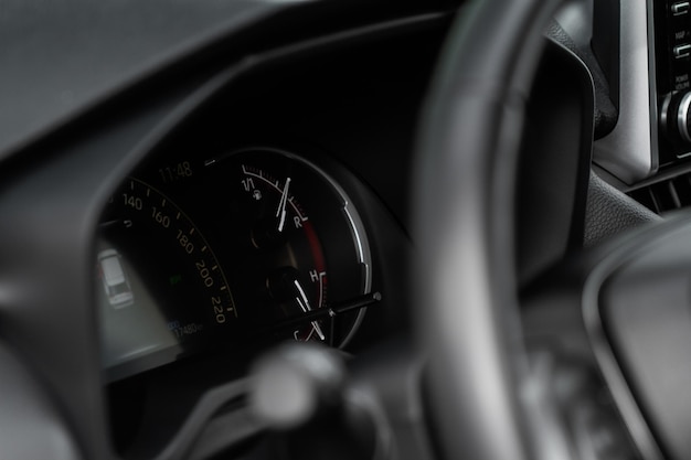 Close up view of a speedometer in a car. Kilometer counter. Car speedometer and dashboard.