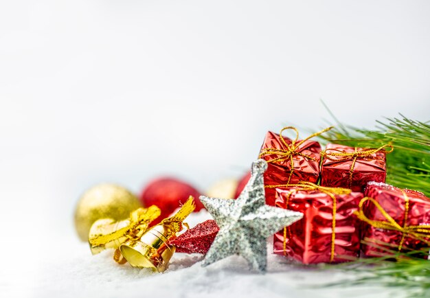 Close up view of star, bell, gift boxes and christmas balls