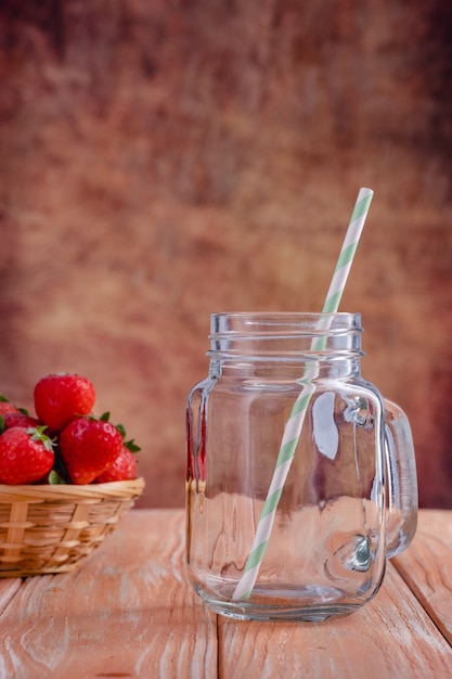 Close up view on strawberry and glass jars