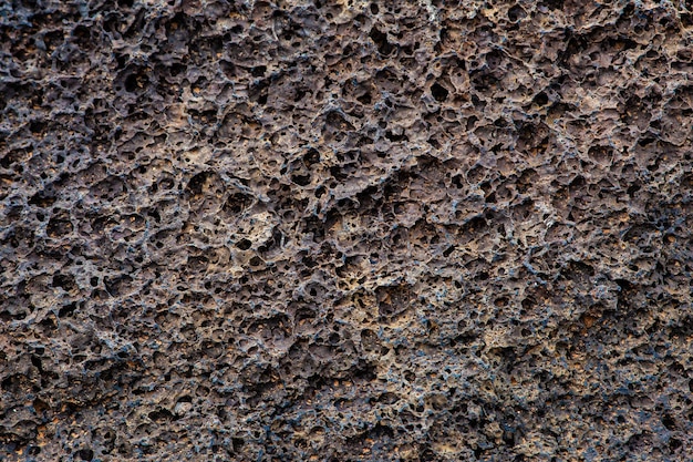 Крупным планом вид на поверхность старого камня. Фон и текстура.