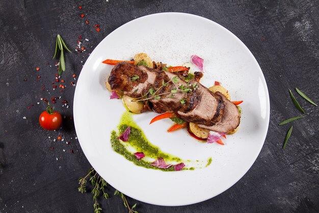 Close up view on tasty grilled and roasted beef with potato, forest mushroom on white plate. Restaurant food for lunch.