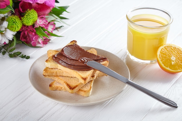 Close up view on toast with Peanut butter and orange juice