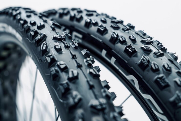 close up view of two bicycle tyres studio shot isolated on white background
