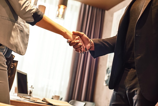 Close up view of two business people shaking hands business communication concept