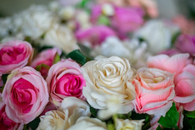 Close up view of two gold wedding rings lying in a bouquet of roses