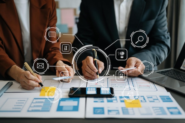 Close up view of UI developer team brainstorming on their project with laptop smartphone and digital tablet Creative digital development agency with virtual icon