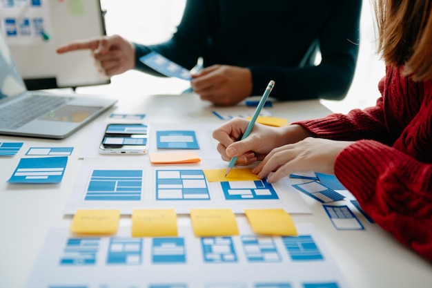 Close up view of UI developer team brainstorming on their project with laptop smartphone and digital tablet Creative digital development agency
