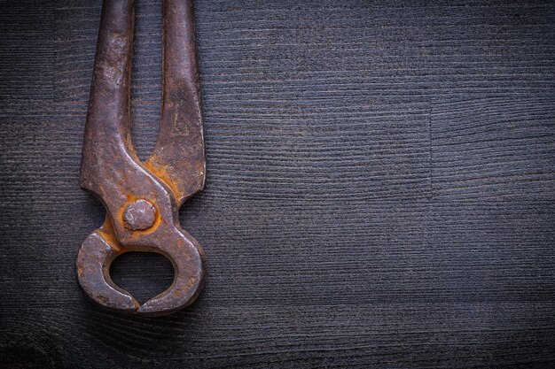 Close up view vintage nippers on wood board