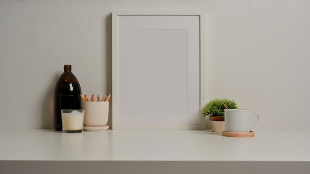 Close up view of white desk with photo frame stationery cup decorations