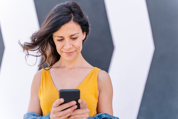 Close up view of woman connecting with technology with friends and family.