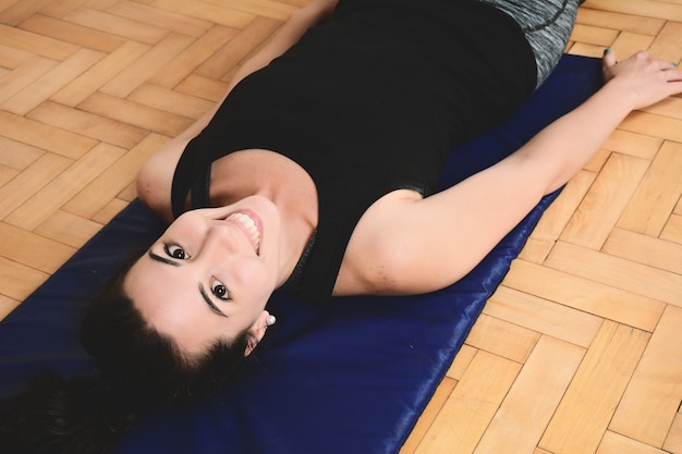 Close up view of woman doing exercise indoors