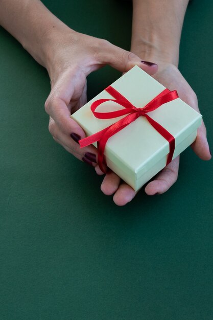 Close up view of woman hands holding a gift box space for text