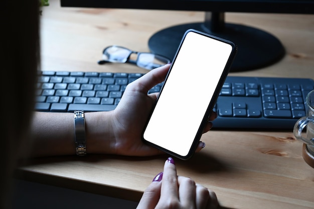 Close up view woman holding smart phone and pointing on empty screen