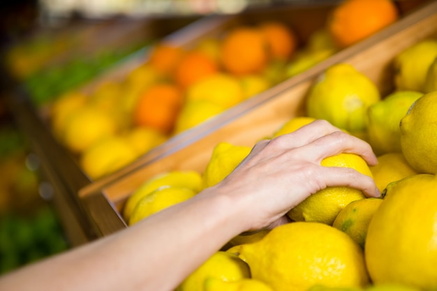 Close up view of a woman picking orange