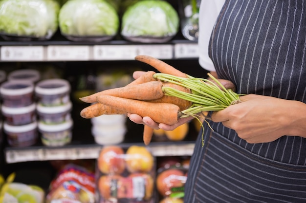 Close up view of woman showing carrot 