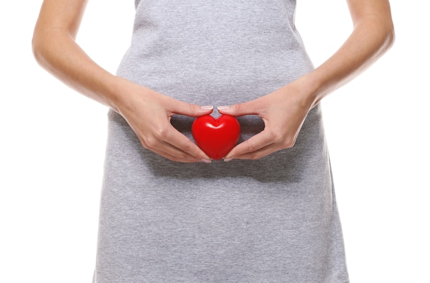 Close up view of woman with red heart on white