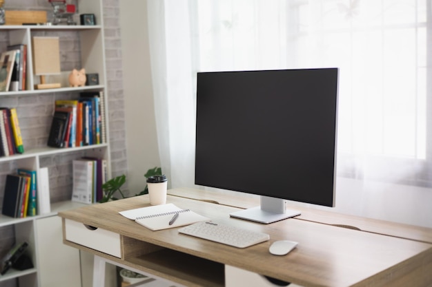 Close up view of worktable with laptop or computer tablet notebook and pen in home office room Work at home place in the living room concept