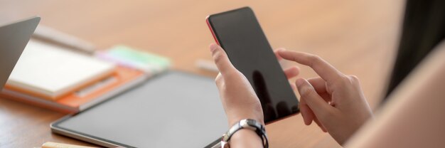 Close up view of young female college student using smartphone to relax