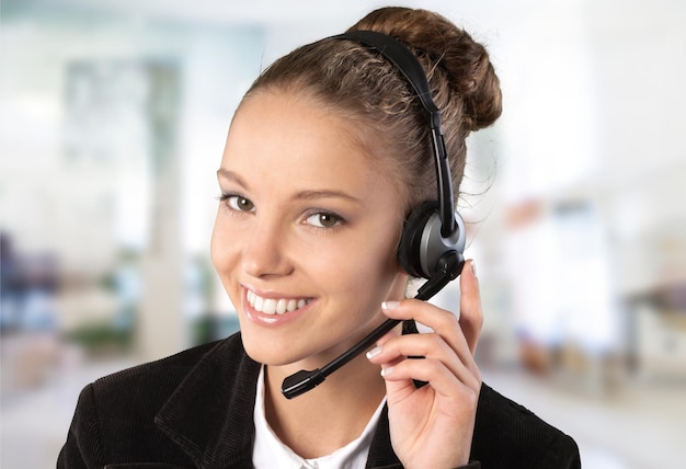 Photo close-up view of young woman  with headphones, call center or support concept