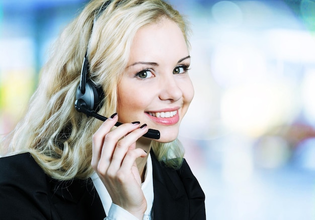 Close-up view of young woman  with headphones, call center or support concept