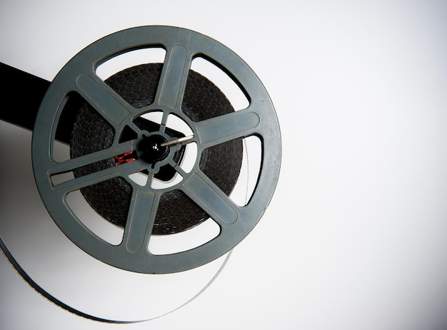 Close-up of vintage film reel against white background