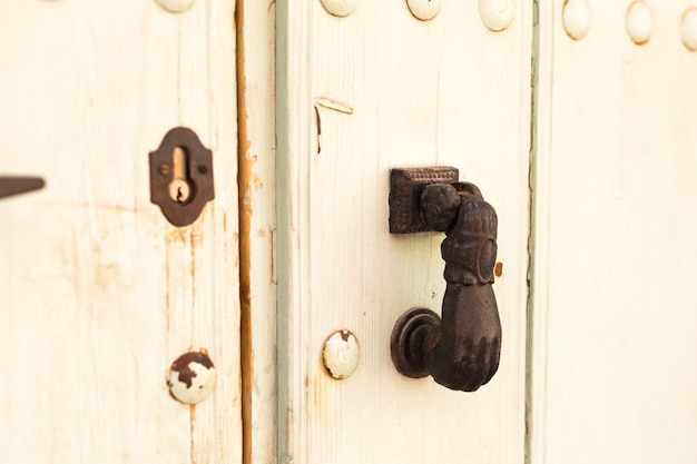 Close-up. Vintage handle for knocking on the door in the form of a hand.