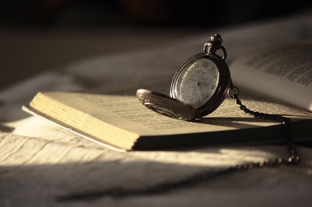 Photo close-up of vintage pocket watch on book