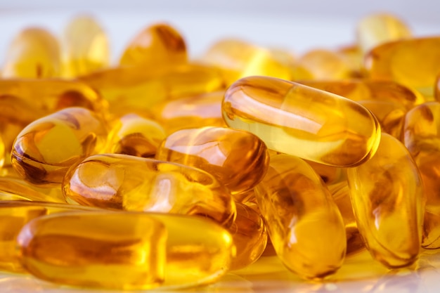 Close up the vitamin D and Omega 3 fish oil capsules supplement  