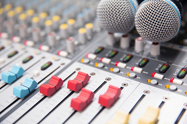 Close-up volume slide of digital sound mixer in the studio.