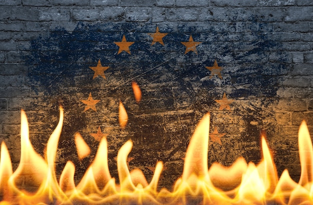 Close up wall with painted European Union EU flag in flames as symbol of world on fire, danger, political, economic crisis or pandemic